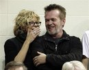 Actress Meg Ryan, left, talks with performer John Mellencamp during the second half of an NCAA college basketball game between Indiana and Ohio State , Saturday, Dec. 31, 2011, in Bloomington, Ind. Indiana won 74-70.