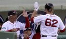 Boston Red Sox manager Bobby Valentine, left, high-fives Lars Anderson after Anderson hit a grand slam during the seventh inning of a spring training baseball game against the Minnesota Twins Sunday, March 4, 2012, in Fort Myers, Fla.