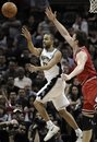 San Antonio Spurs ' Tony Parker , left, of France, passes the ball away from Chicago Bulls ' Omer Asik , of Turkey, during the second half of an NBA basketball game, Wednesday, Feb. 29, 2012, in San Antonio. Chicago won 96-89.