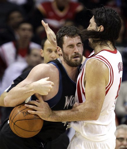 Minnesota Timberwolves' Kevin Love, Left, Charges