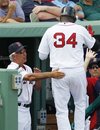 Boston Red Sox manager Bobby Valentine congratulates David Ortiz , who scored on a single by Cody Ross in the fourth inning of a spring training baseball game against the Miami Marlins in Fort Myers, Fla., Monday, March 12, 2012.