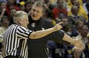 West Virginia coach Bob Huggins argues with referee Jim Burr in the second half of an NCAA college basketball game against Marquette in Morgantown, W.Va., on Friday, Feb. 24, 2012. Marquette won 61-60.