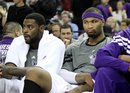 Sacramento Kings ' Tyreke Evans , left, and DeMarcus Cousins watch the closing moments of the Kings loss to the San Antonio Spurs in a NBA basketball game in Sacramento, Calif., Wednesday, March 28, 2012. The Spurs won 117-112.
