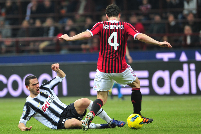 Juventus Defender Leonardo Bonucci (L) Fights For The Ball With AC Milan's Dutch Defender Mark Van Bommel On February