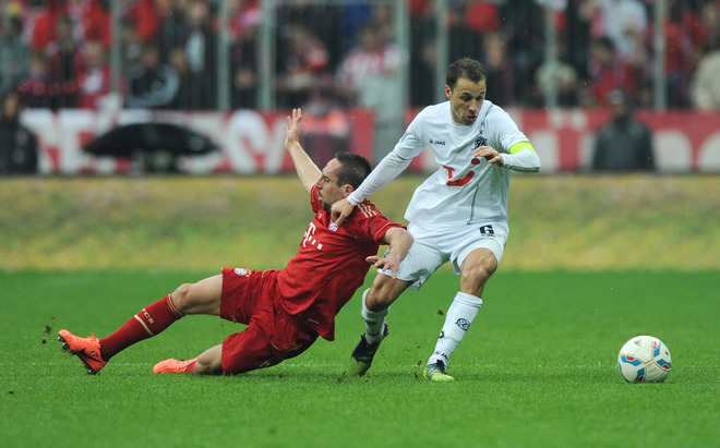 Bayern Munich's French Midfielder Franck Ribery (L) And Hanover's US Defender Steven Cherundolo (R) Challenge For The