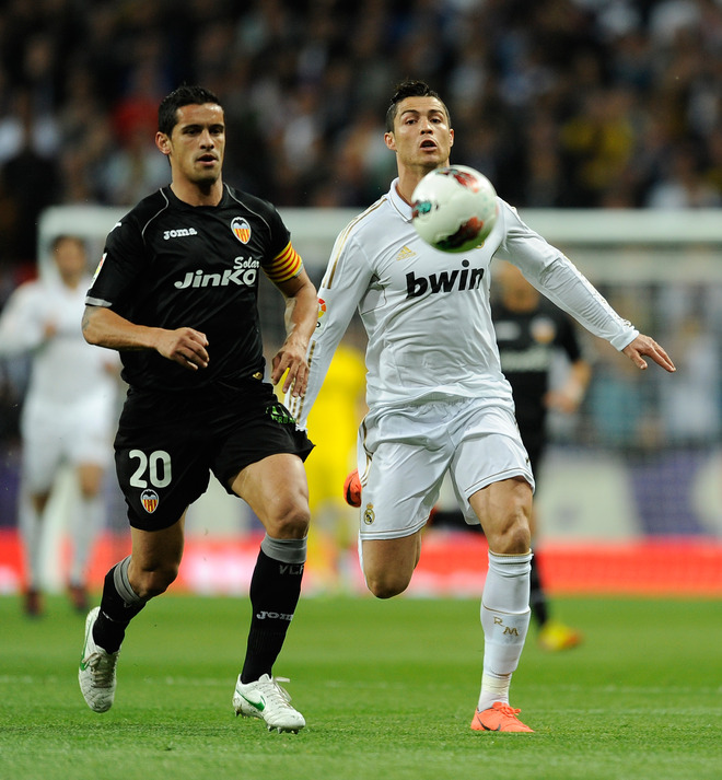 Real Madrid's Portuguese Forward Cristiano Ronaldo (R) Vies For The Ball With  Valencia's Portuguese Defender Ricardo