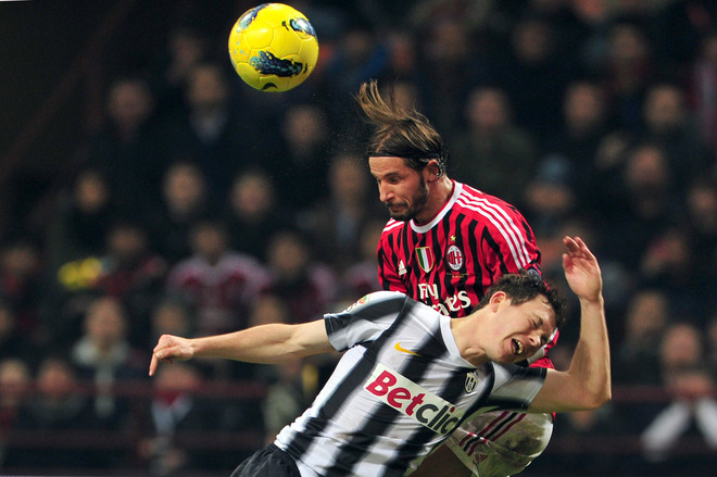 Juventus' Swiss Defender Stephan Lichtseiner (R) Jumps For The Ball With AC Milan Defender Luca Antonini On February 25,