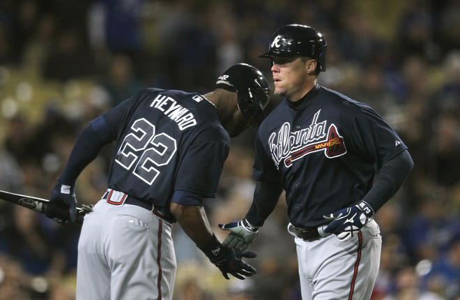   Chipper Jones #10 Of The Atlanta Braves Is Greeted By On Deck Hitter Jason Heyward #22 As He Returns To The Dugout