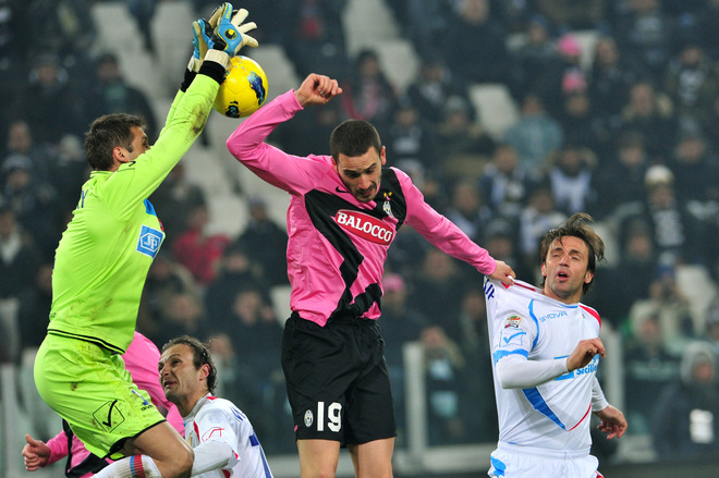 Juventus' Defender Leonardo Bonucci (C)  Challanges For The Ball With Catania's Defender Nicola Legrottaglie (R) And