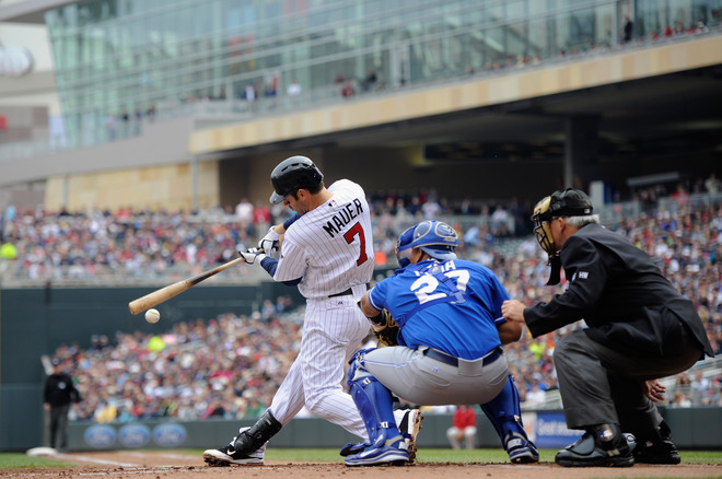  Joe Mauer #7 Of The Minnesota Twins Hits An RBI Single As Brayan Pena #27 Of The Kansas City Royals Catches And Home