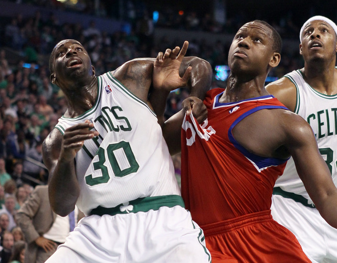   Brandon Bass #30 Of The Boston Celtics And Lavoy Allen #50 Of The Philadelphia 76ers Battle For Position In Game One