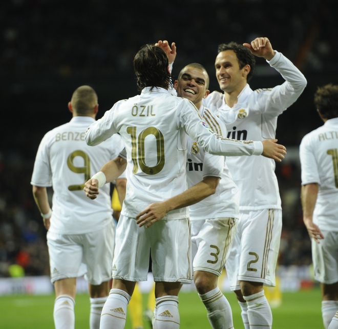 Real Madrid's German Midfielder Mesut Ozil (2L) Celebrates