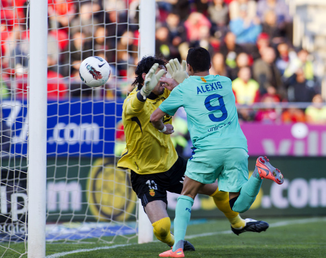 Barcelona's Chilean Forward Alexis Sanchez (R) Scores