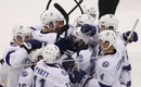 WINNIPEG, CANADA - APRIL 7: Teddy Purcell #16 of the Tampa Bay Lightning is swarmed by his teammates after scoring an overtime goal against the Winnipeg Jets in NHL action at the MTS Centre on April 7, 2012 in Winnipeg, Manitoba, Canada. (Photo by Marianne Helm/Getty Images)