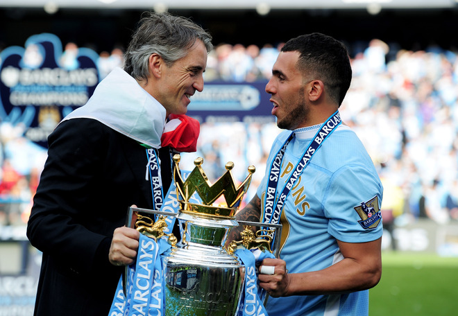   (L-R) Roberto Mancini The Manager Of Manchester City And Carlos Tevez Of Manchester City Celebrate With The Trophy