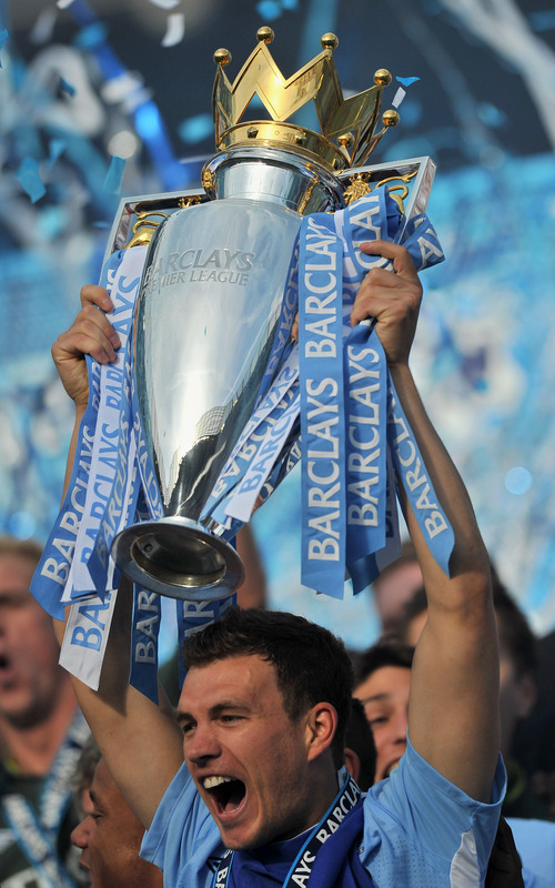 Manchester City's Bosnian Striker Edin Dzeko Lifts The Premier League Trophy 

RESTRICTED TO EDITORIAL USE. No Use With