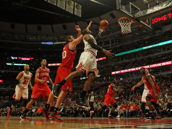  C.J. Watson #7 Of The Chicago Bulls Puts Up A Shot Past Spencer Hawes #00 Of The Philadelphia 76ers In Game Five Of