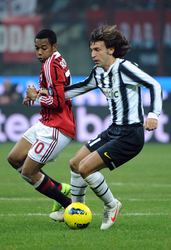 AC Milan's Brazilian Forward Robinho (L) Fights For The Ball With Juventus Midfielder Andrea Pirlo On February 25, 2012