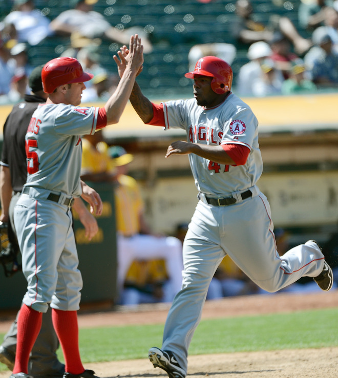   Peter Bourjos #25 And Howie Kendrick #47 Of The Los Angeles Angels Of Anaheim Both Celebrate
