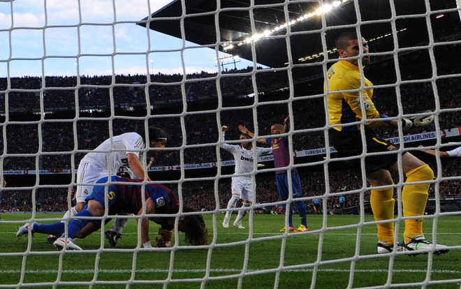 Real Madrid's German Midfielder Sami Khedira (L) Scores Against Barcelona's Goalkeeper Victor Valdes (R) And