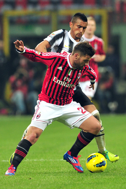 AC Milan's Defender Antonio Nocerino (front) Fights For The Ball With Juventus Midfielder Arturo Vidal Of Chile On