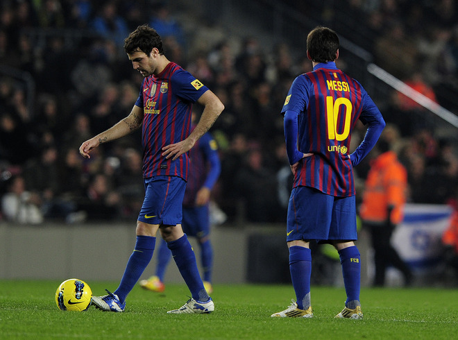 Barcelona's Argentinian Forward Lionel Messi (R) And Barcelona's Midfielder Cesc Fabregas (L) React