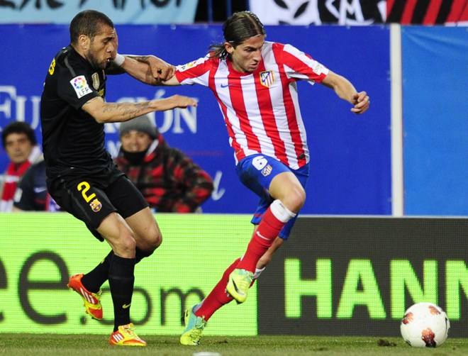 Atletico Madrid's Brazilian Defender Filipe Luis Kasmirski (R) Vies For The Ball With Barcelona's Brazilian Defender