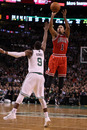 BOSTON, MA - JANUARY 13:  Derrick Rose #1 of the Chicago Bulls takes a shot as Rajon Rondo #9 of the Boston Celtics defends on January 13, 2012 at TD Garden in Boston, Massachusetts. The Chicago Bulls defeated the Boston Celtics 88-79. NOTE TO USER: User expressly acknowledges and agrees that, by downloading and or using this photograph, User is consenting to the terms and conditions of the Getty Images License Agreement.  (Photo by Elsa/Getty Images)