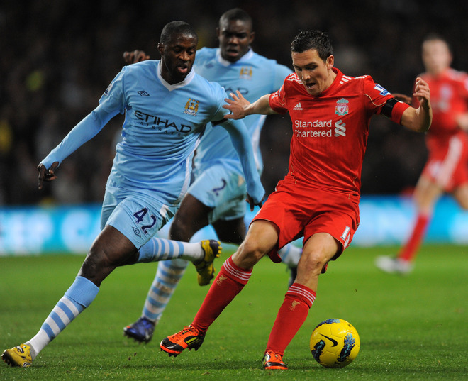 Liverpool's English Footballer Stewart Downing (R) Vies For The Ball Against Manchester City's Ivory Coast Footballer