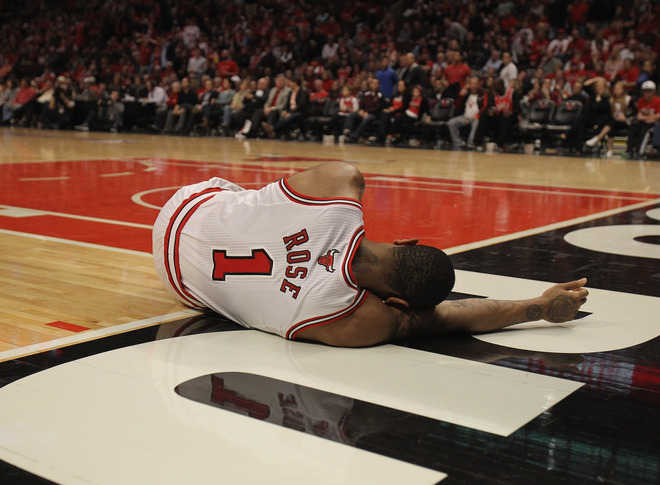  Derrick Rose #1 Of The Chicago Bulls Lays On The Floor Aftrer Suffering An Injury Against The Philadelphia 76ers In