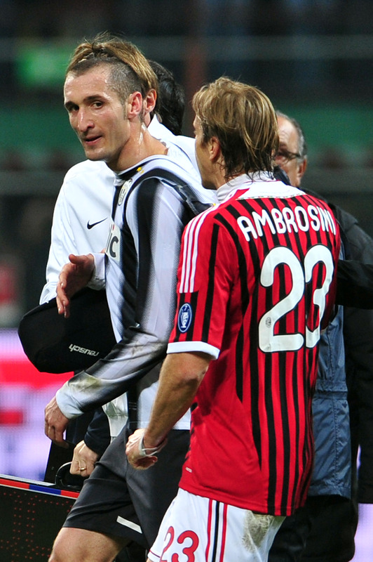 AC Milan Midfielder And Captain Massimo Ambrosini (R) Holds
