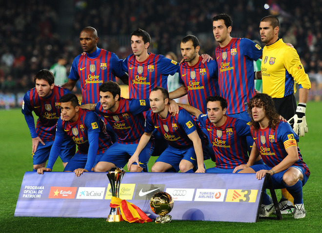 FC Barcelona's Players Pose With The Ballon D'or And World Champions Trophies On January 15, 2012            AFP PHOTO