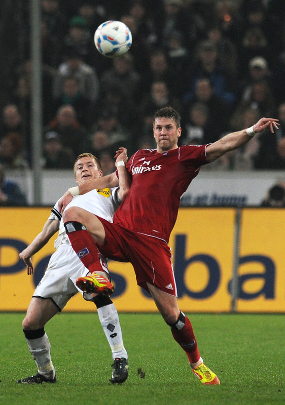 Moenchengladbach's Midfielder Marco Reus And Hamburg's Defender Dennis Diekmeier (R) Vie For The Ball RESTRICTIONS /