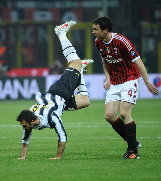 Juventus Forward Mirko Vucinic (L) Of Montenegro Fights For The Ball With AC Milan's Dutch Defender Mark Van Bommel On