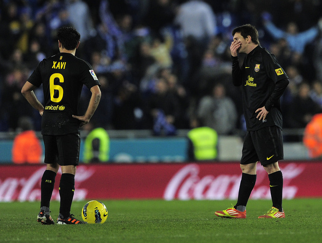 Barcelona's Argentinian Forward Lionel Messi (R) And Barcelona's Midfielder Xavi Hernandez (L) Gesture