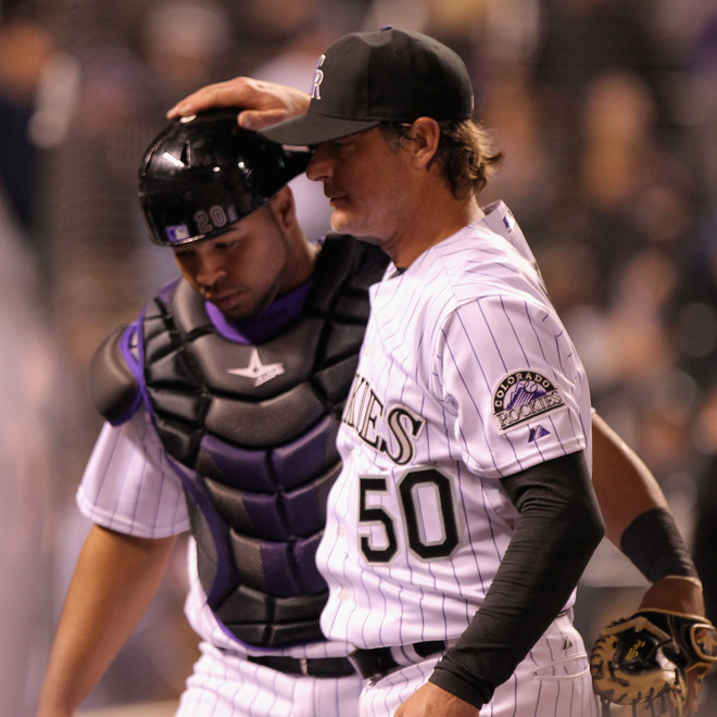   Starting Pitcher Jamie Moyer #50 Of The Colorado Rockies Returns To The Dugout With Catcher Wilin Rosario #20 Of The