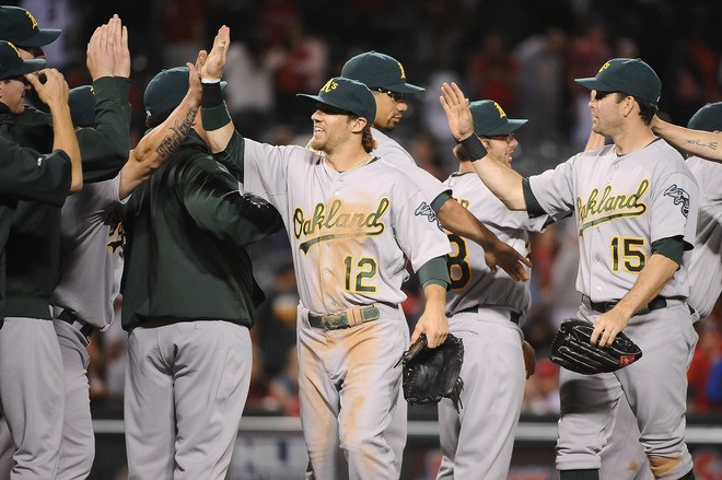   Collin Cowgill #12 And Seth Smith #15 Of The Oakland Athletics Celebrate