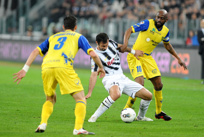 Juventus Forward Mirko Vucinic (C) Of Montenegro Fights For The Ball With Chievo Defender Marco Andreolli (L) And