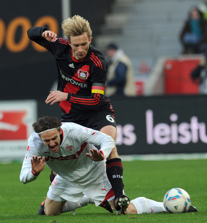 Stuttgart's Midfielder Christian Gentner And Leverkusen's Midfielder Simon Rolfes (top) Vie For The Ball RESTRICTIONS