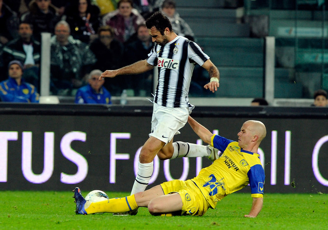   Mirko Vucinic Of Juventus FC And Michael Bradley Of AC Chievo Verona Compete For The Ball