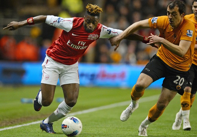Wolverhampton Wanderers' Serbian Midfielder Nenad Milijas (R) Vies With Arsenal's Cameroonian Midfielder Alex Song (L) 