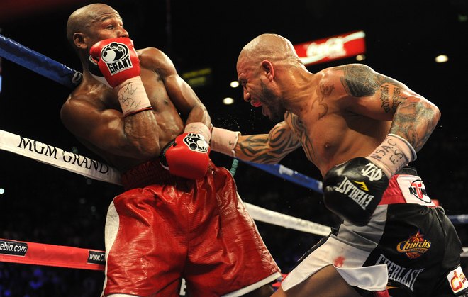 US Boxer Floyd Mayweather Jr. (L) And Puerto Rico's Miguel Cotto (R) Duel It Out On May 5, 2012 In Las Vegas, Nevada,