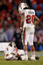 CHARLOTTE, NC - DECEMBER 27: Victor Anderson #20 of the Louisville Cardinals checks on teammate Teddy Bridgewater #5 of the Louisville Cardinals after a hard hit during their game against the North Carolina State Wolfpack at Bank of America Stadium on December 27, 2011 in Charlotte, North Carolina. (Photo by Streeter Lecka/Getty Images)