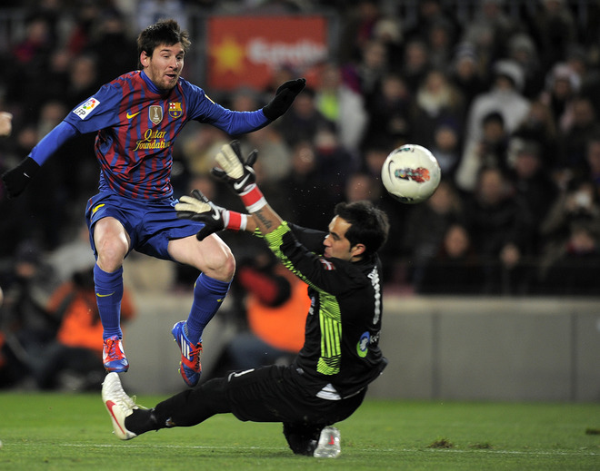 Barcelona's Argentinian Forward Lionel Messi (L) Scores A Goal Past Real Sociedad's Chilean Goalkeeper Claudio Bravo