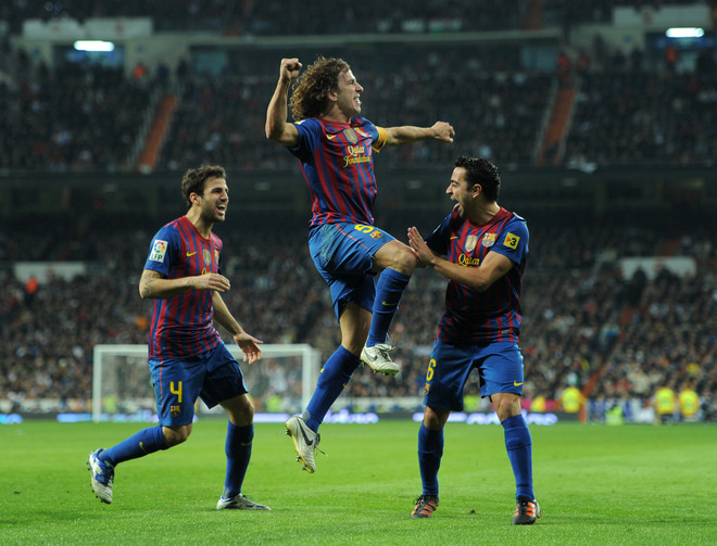   Carles Puyol (C) Of FC Barcelona Celebrates Scoring His Sides Equalizing Goal With His Teammates Xavi Hernandez (R)