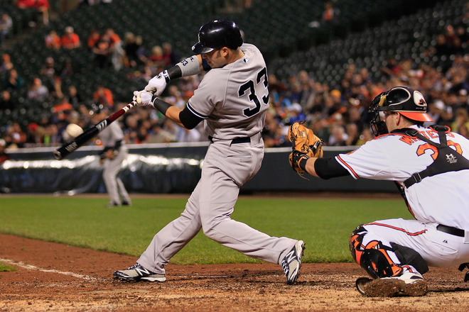  Nick Swisher #33 Of The New York Yankees Hits A Two RBI Double As Catcher Matt Wieters #32 Of The Baltimore Orioles