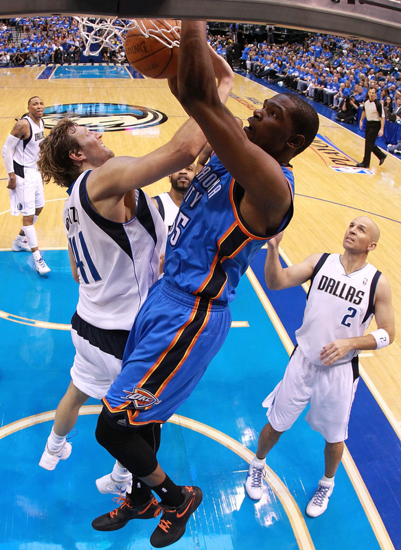   Kevin Durant #35 Of The Oklahoma City Thunder Slam Dunks The Ball Against Dirk Nowitzki #41 Of The Dallas Mavericks