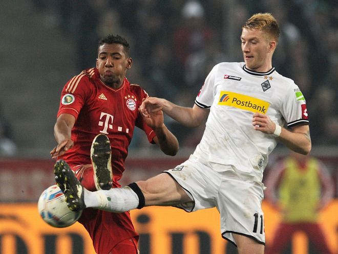 Moenchengladbach's Midfielder Marco Reus (R) And Bayern Munich's Defender Jerome Boateng Vie For The Ball 