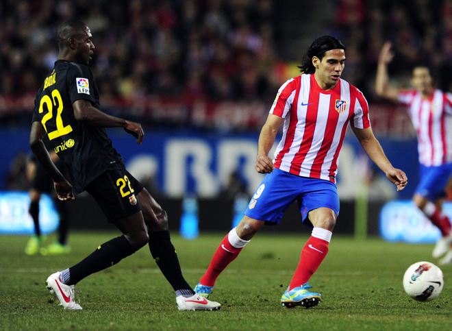 Atletico Madrid's Colombian Midfielder Radamel Falcao Garcia (R) Vies For The Ball With Barcelona's French Defender