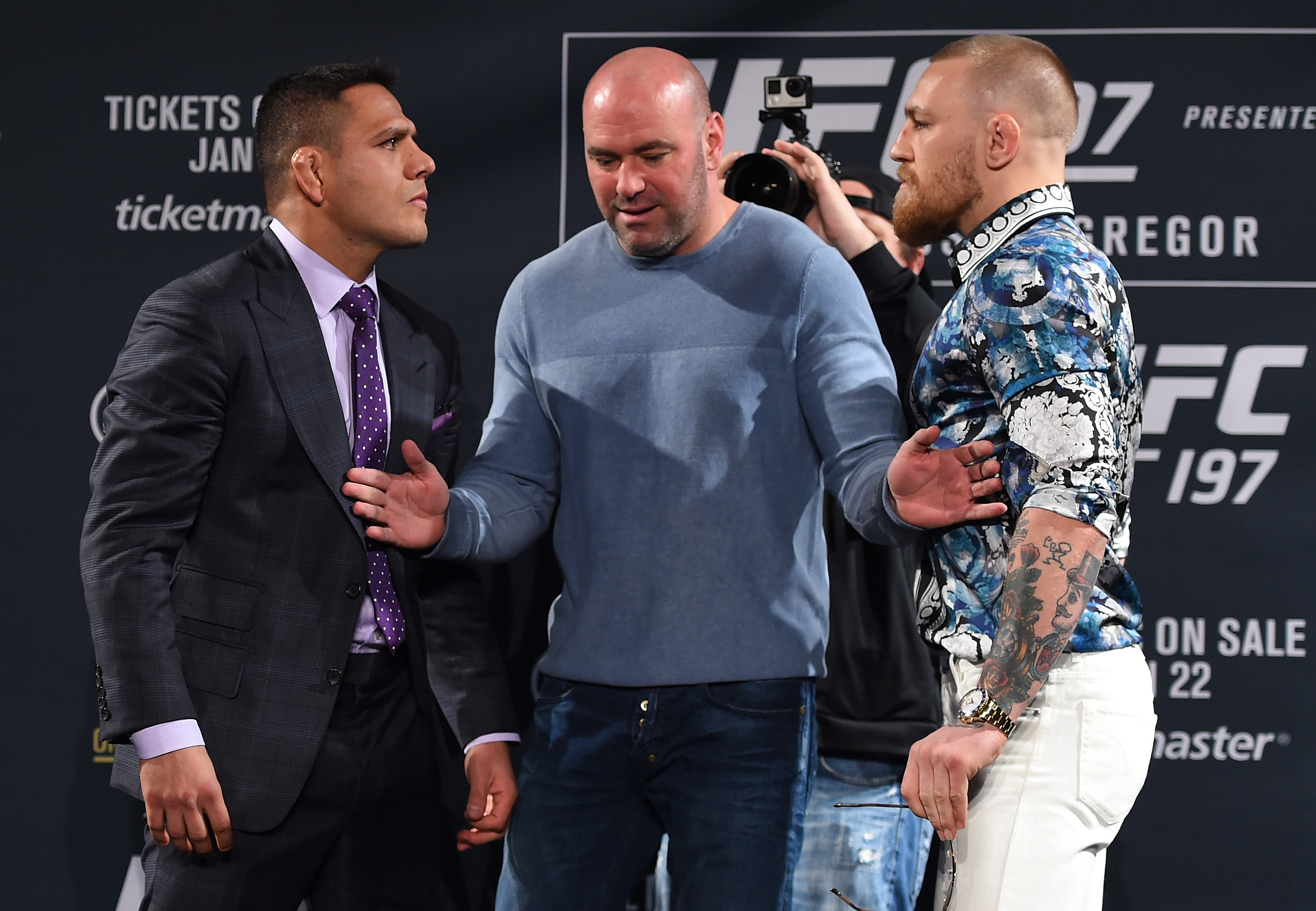 Dana White separates Rafael dos Anjos (L) and Conor McGregor during a face-off. (Getty)